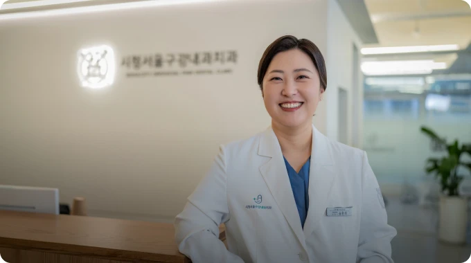 시청서울구강내과 로고 사인월 앞에서 미소 짓는 대표원장